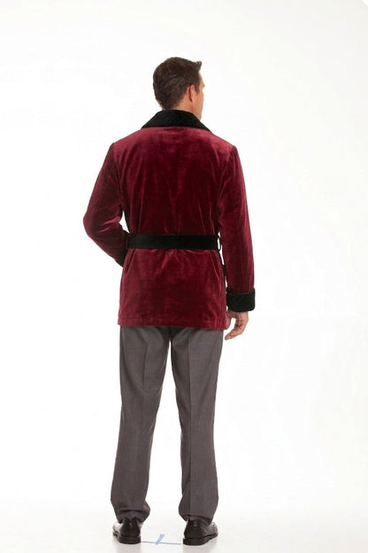 Person wearing a red velvet coat and gray pants on a white background